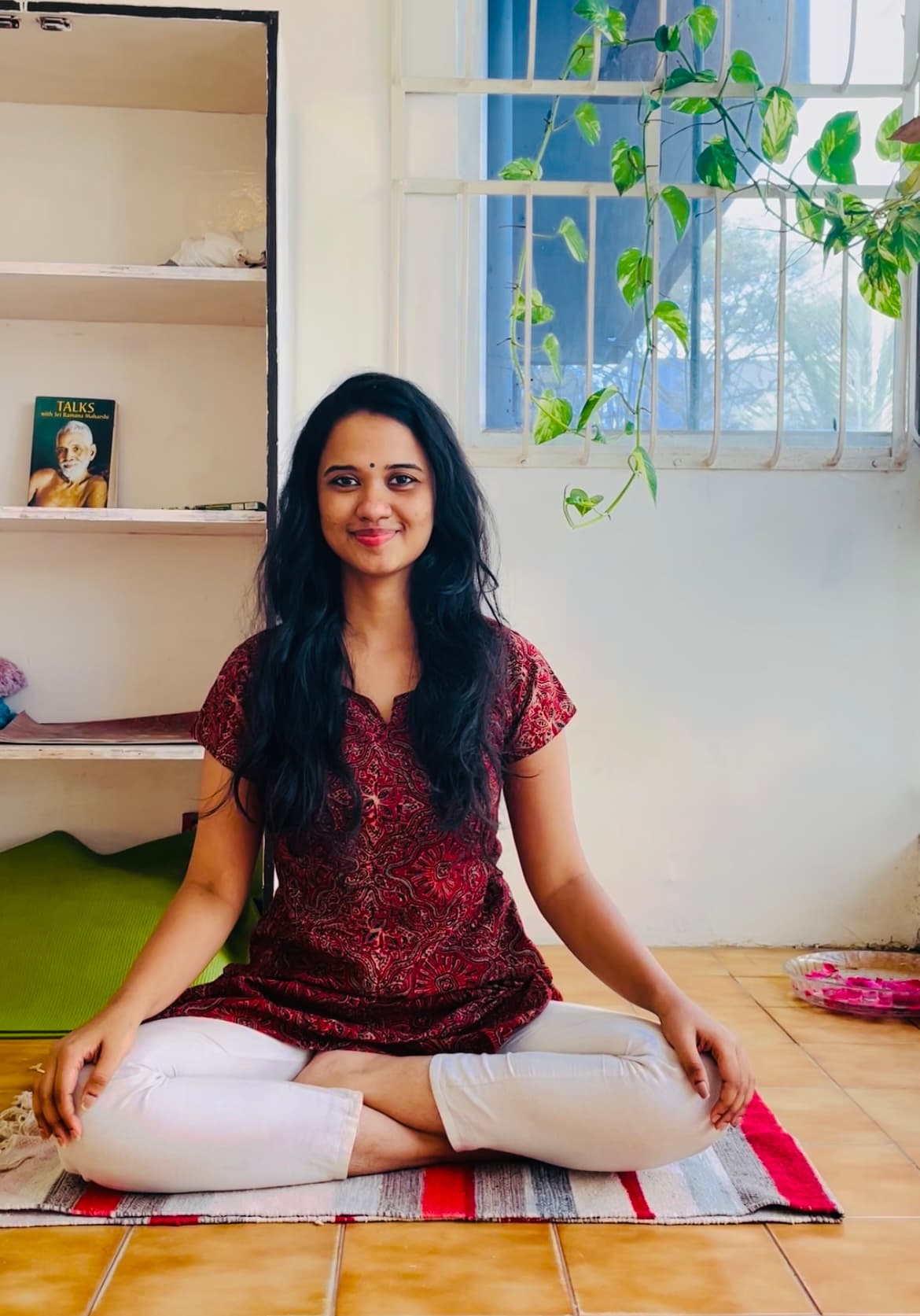Archya Venkatesh, founder of Wombhood, sitting in meditation pose